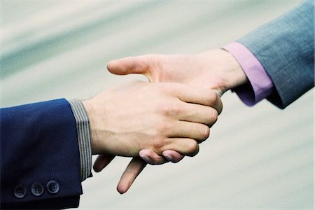 Hesitant handshake between professionals Stock Photo - Premium Royalty-Free, Code: 695-05770033