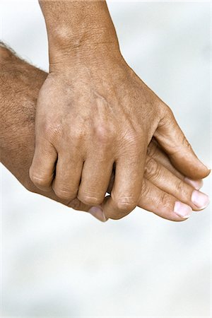 Woman's hand holding man's hand, close-up Stock Photo - Premium Royalty-Free, Code: 695-05770044