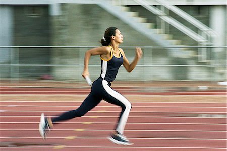 relay run - Woman running on track Stock Photo - Premium Royalty-Free, Code: 695-05770081