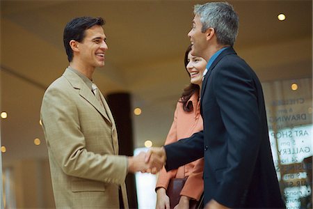 friendly young man - Business associates shaking hands Stock Photo - Premium Royalty-Free, Code: 695-05770131