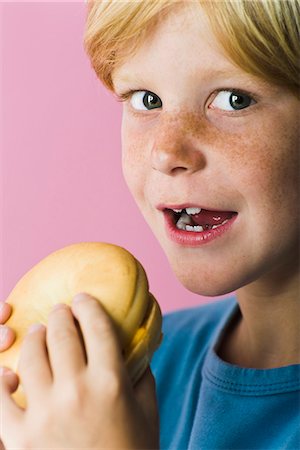 Boy with ham and cheese sandwich Stock Photo - Premium Royalty-Free, Code: 695-05770278