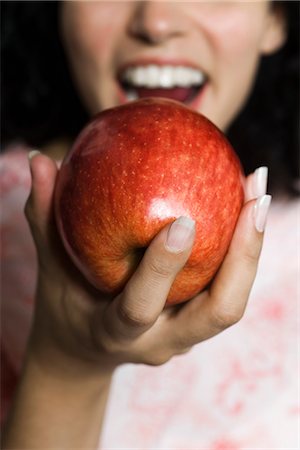 fresh food - Woman eating apple, cropped Stock Photo - Premium Royalty-Free, Code: 695-05770309