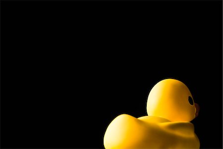 simsearch:695-05770356,k - Rubber duck, on black background, rear view Stock Photo - Premium Royalty-Free, Code: 695-05770333