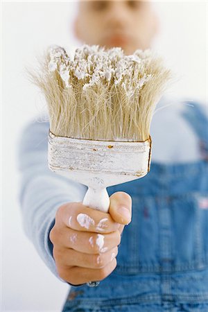 painter, male - Man holding out paintbrush Stock Photo - Premium Royalty-Free, Code: 695-05770393