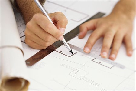 drawing person white background - Architect editing blueprint, close-up Stock Photo - Premium Royalty-Free, Code: 695-05770402