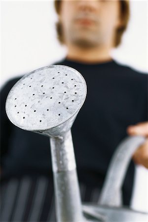Man with watering can, cropped Stock Photo - Premium Royalty-Free, Code: 695-05770403