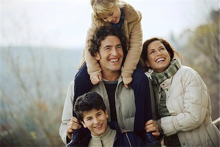 Family together outdoors, father carrying daughter on his shoulders Stock Photo - Premium Royalty-Free, Code: 695-05770595