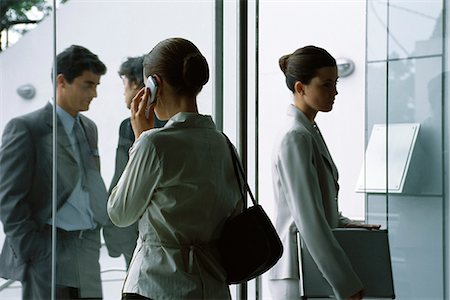 Executives arriving and departing through entrance of office building Stock Photo - Premium Royalty-Free, Code: 695-05770630