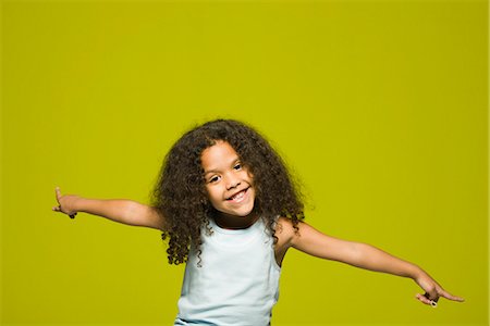 Little girl with arms outstretched, portrait Stock Photo - Premium Royalty-Free, Code: 695-05770693