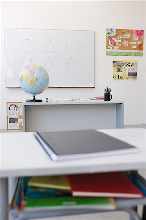 Classroom, school desk full of books and notebooks Stock Photo - Premium Royalty-Free, Code: 695-05770715