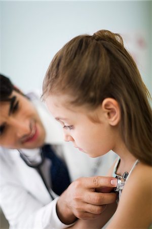 physical exam child - Pediatrician listening to little girl's chest with stethoscope Stock Photo - Premium Royalty-Free, Code: 695-05770776