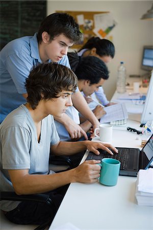 school friends standing - Male college students working together using laptop computer Stock Photo - Premium Royalty-Free, Code: 695-05770825