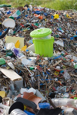 full of garbage in dust bin - Full garbage can in midst of landfill Stock Photo - Premium Royalty-Free, Code: 695-05770903