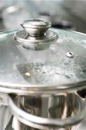 Water Boiling in Amber Glass Pot - Stock Image - C036/3727