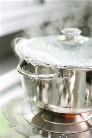 Water Boiling in Amber Glass Pot - Stock Image - C036/3727