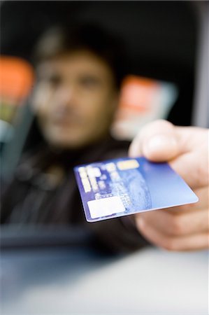 driver (car, male) - Customer in drive-thru holding out credit card Stock Photo - Premium Royalty-Free, Code: 695-05770984