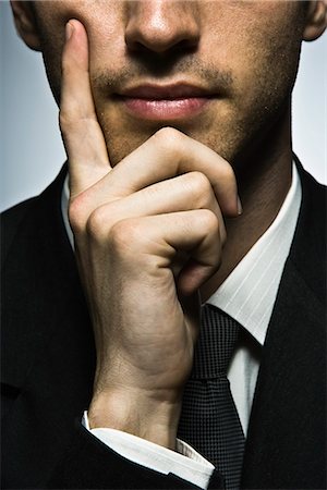 portrait business person close thinking not looking at camera - Businessman with hand under chin, portrait Stock Photo - Premium Royalty-Free, Code: 695-05770980