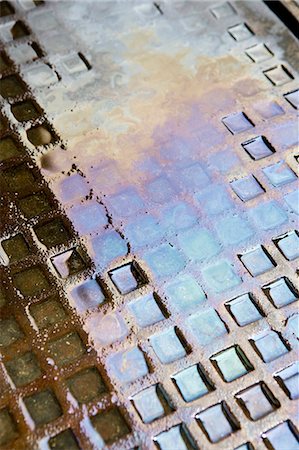 Motor oil in water puddle on ground Stock Photo - Premium Royalty-Free, Code: 695-05771042