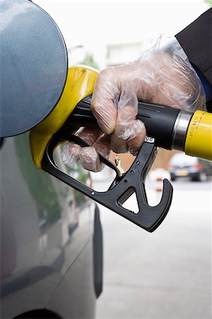 refuel - Refueling vehicle, wearing disposable glove Stock Photo - Premium Royalty-Free, Code: 695-05771064