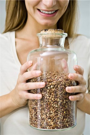 Holding jar of dried lentils Stock Photo - Premium Royalty-Free, Code: 695-05771172