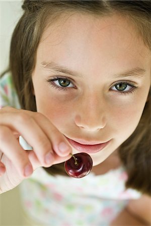 Girl eating cherry Stock Photo - Premium Royalty-Free, Code: 695-05771180