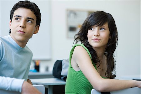 High school students in class, looking over shoulders with interest Stock Photo - Premium Royalty-Free, Code: 695-05771375