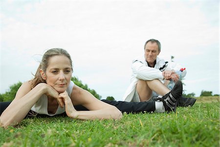 Mature couple stretching in park Stock Photo - Premium Royalty-Free, Code: 695-05771579