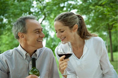 Mature couple enjoying red wine outdoors Stock Photo - Premium Royalty-Free, Code: 695-05771588