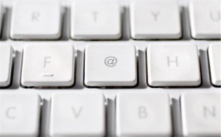 At sign on laptop computer keyboard Stock Photo - Premium Royalty-Free, Code: 695-05771644