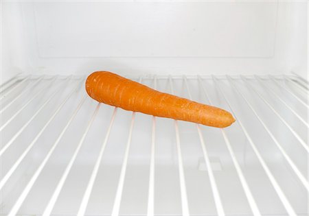 Single carrot sitting on shelf inside refrigerator Stock Photo - Premium Royalty-Free, Code: 695-05771655