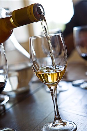 stemware - Pouring glass of white wine Stock Photo - Premium Royalty-Free, Code: 695-05771676