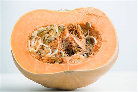 sprout - Sprouting pumpkin seeds and fibrous strands within cut pumpkin, cross section Stock Photo - Premium Royalty-Free, Code: 695-05771775