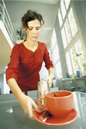 simsearch:695-05772228,k - Woman picking up cup and saucer Stock Photo - Premium Royalty-Free, Code: 695-05772204