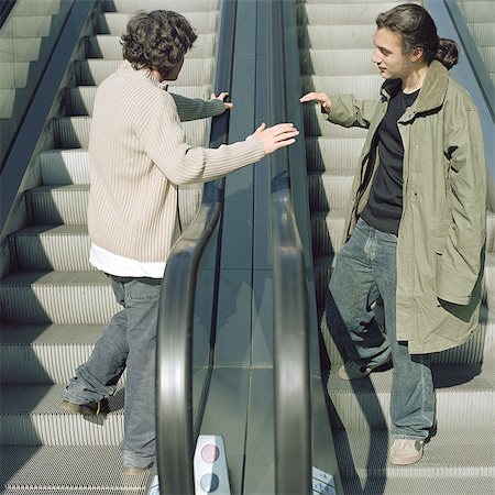 Two young men on escalators Stock Photo - Premium Royalty-Free, Code: 695-05772484