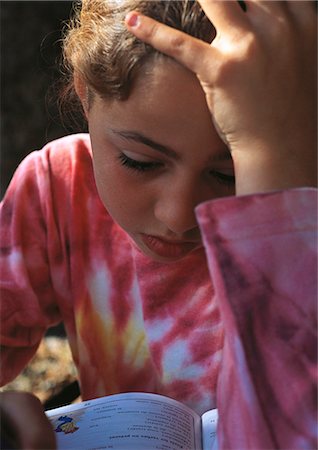 Child doing homework, holding head Stock Photo - Premium Royalty-Free, Code: 695-05772546