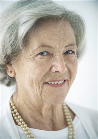 Elderly woman smiling, portrait Stock Photo - Premium Royalty-Free, Code: 695-05772667