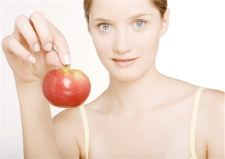 Woman holding up apple Stock Photo - Premium Royalty-Free, Code: 695-05772729
