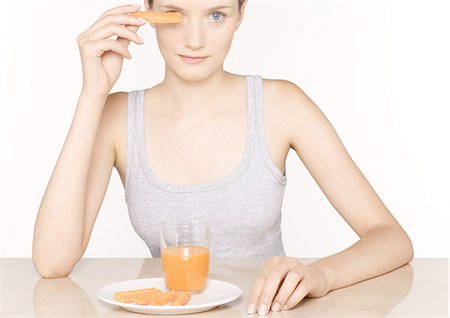 Woman with carrot juice and slices of carrots Stock Photo - Premium Royalty-Free, Code: 695-05772720