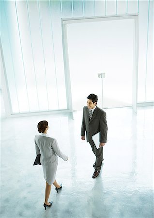 executive welcome - Woman walking to meet businessman in lobby Stock Photo - Premium Royalty-Free, Code: 695-05772769