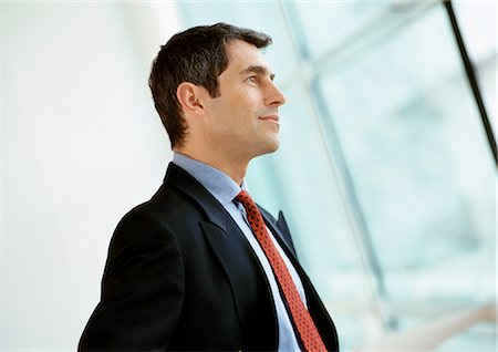 Businessman smiling, looking away, side view Stock Photo - Premium Royalty-Free, Code: 695-05772938