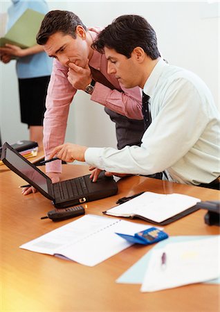 Two businessmen looking at laptop computer Stock Photo - Premium Royalty-Free, Code: 695-05772952
