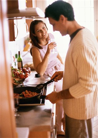 simsearch:695-05770930,k - Man cooking, side view, woman holding glass, smiling Stock Photo - Premium Royalty-Free, Code: 695-05773038
