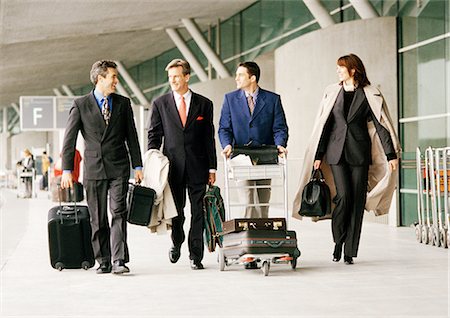 simsearch:695-03388701,k - Group of business people walking with luggage outside airport terminal Stock Photo - Premium Royalty-Free, Code: 695-05773278