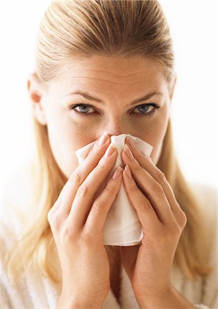 Woman blowing nose, close-up Stock Photo - Premium Royalty-Free, Code: 695-05773369