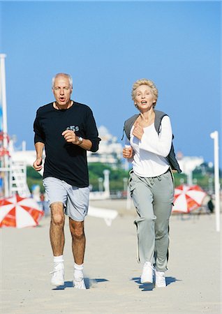 picture of older lady jogging - Mature couple jogging on beach, front view, full length Stock Photo - Premium Royalty-Free, Code: 695-05773410