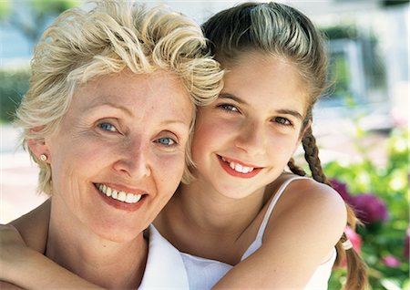 simsearch:695-05773387,k - Young girl hugging mature woman from behind, portrait Stock Photo - Premium Royalty-Free, Code: 695-05773421