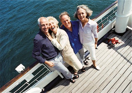 simsearch:695-05775309,k - Mature couples standing next to railing of boat, looking at camera, portrait, high angle view Foto de stock - Sin royalties Premium, Código: 695-05773436