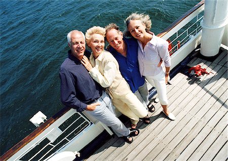 Mature couples standing next to railing of boat, portrait, high angle view Stock Photo - Premium Royalty-Free, Code: 695-05773437