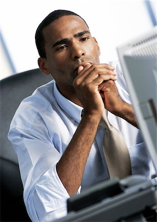 Businessman looking at computer Stock Photo - Premium Royalty-Free, Code: 695-05773643