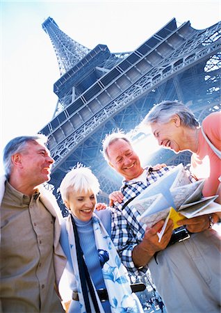 senior couple looking at map - France, Paris, mature tourists examining a map in front of Eiffel Tower, low angle view Stock Photo - Premium Royalty-Free, Code: 695-05773676